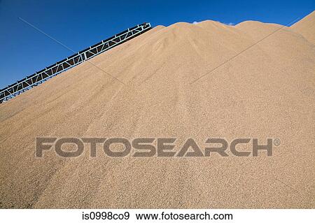 Conveyor belt over mound of sand at quarry View Large Photo Image Stock Photo - Conveyor belt over mound of sand at quarry. Fotosearch