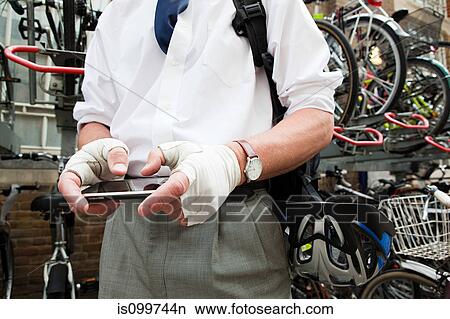 Cyclist using smartphone View Large Photo Image Picture - Cyclist using smartphone. Fotosearch
