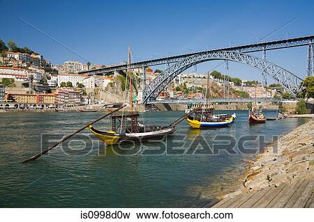 Dom Luis bridge over the Douro river with moored traditional port wine boats, Porto, Portugal View Large Photo Image Stock Photo - Dom Luis bridge over the Douro river with moored traditional port wine boats, Porto, Portugal. Fotosearch