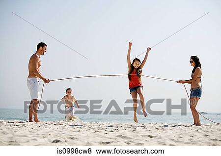 Family holding running competition on a beach View Large Photo Image Stock Photo - Family holding running competition on a beach. Fotosearch