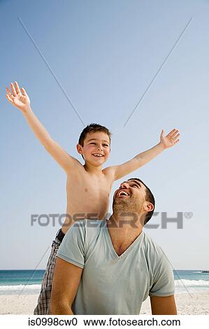 Father and son enjoying quality time together on the beach View Large Photo Image Stock Image - Father and son enjoying quality time together on the beach. Fotosearch