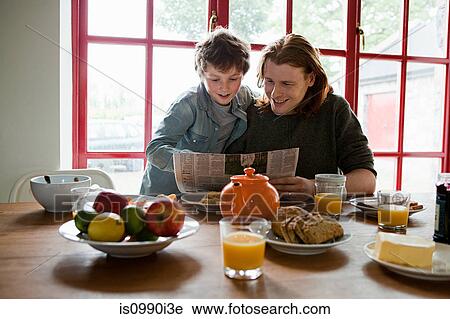 Father and son having breakfast View Large Photo Image Stock Image - Father and son having breakfast. Fotosearch