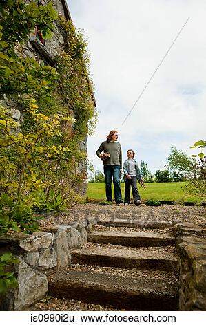 Father and son walking toward steps View Large Photo Image Stock Photograph - Father and son walking toward steps. Fotosearch