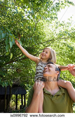 Father carrying daughter on shoulders View Large Photo Image Stock Image - Father carrying daughter on shoulders. Fotosearch