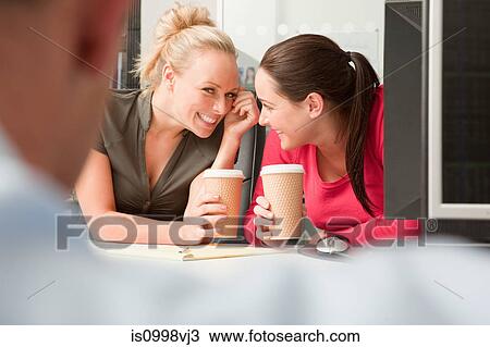 Female colleagues sharing a secret about a male colleague View Large Photo Image Stock Image - Female colleagues sharing a secret about a male colleague. Fotosearch