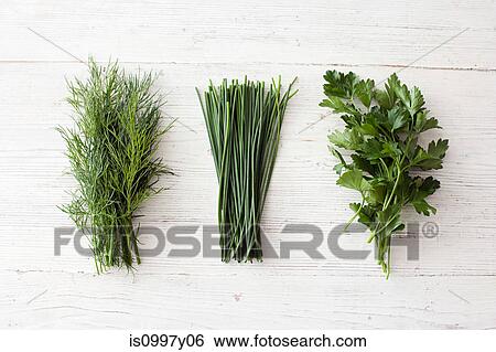 Stock Photograph - Freshly cut dill, chives and flat leaf parsley. Fotosearch