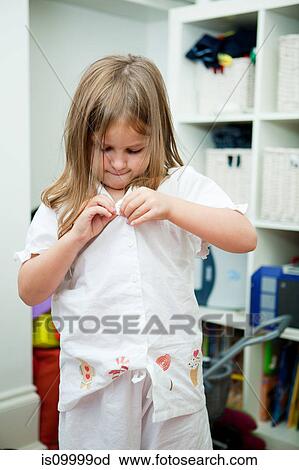 Girl buttoning white shirt View Large Photo Image Stock Image - Girl buttoning white shirt. Fotosearch