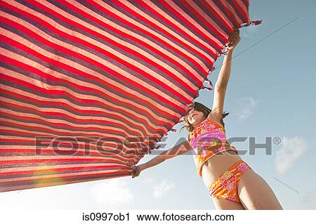 Girl holding beach blanket View Large Photo Image Stock Image - Girl holding beach blanket. Fotosearch