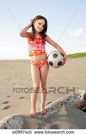 Girl holding soccer ball at beach View Large Photo Image Stock Photography - Girl holding soccer ball at beach. Fotosearch