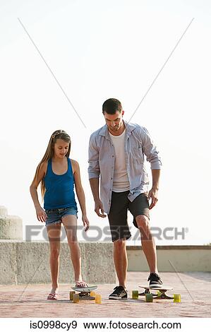 Stock Photo - Girl learning how to use a skateboard. Fotosearch