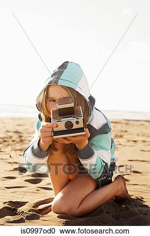 Girl with instant camera at beach View Large Photo Image Stock Image - Girl with instant camera at beach. Fotosearch