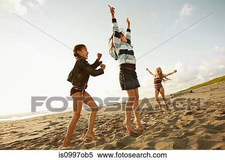 Girls playing on beach View Large Photo Image Stock Photography - Girls playing on beach. Fotosearch