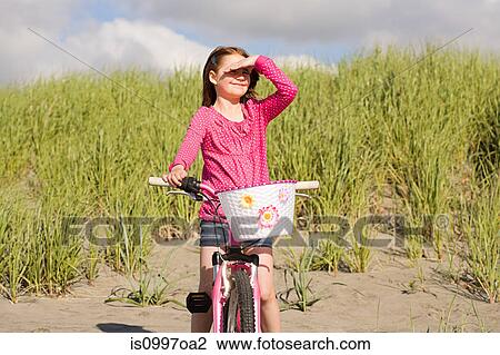 Girls shielding eyes at beach View Large Photo Image Stock Image - Girls shielding eyes at beach. Fotosearch