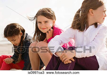 Girls sitting at beach View Large Photo Image Stock Image - Girls sitting at beach. Fotosearch