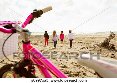 Girls walking over sand at beach View Large Photo Image Stock Photography - Girls walking over sand at beach. Fotosearch