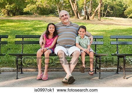 Grandfather sitting with grandchildren in park, portrait View Large Photo Image Stock Image - Grandfather sitting with grandchildren in park, portrait. Fotosearch