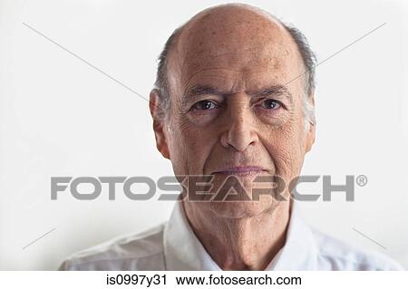 Stock Image - Head shot of senior man looking displeased. Fotosearch