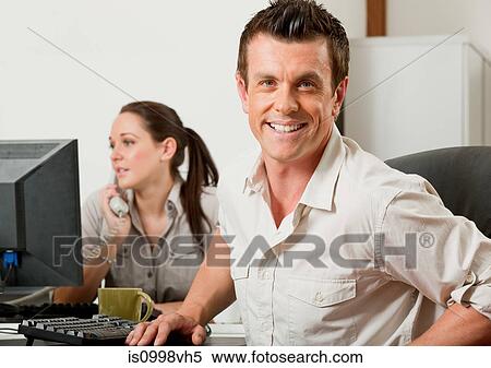 Man getting up from behind his desk View Large Photo Image Stock Photography - Man getting up from behind his desk. Fotosearch