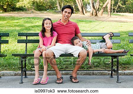 Man with son and daughter on park bench, portrait View Large Photo Image Stock Image - Man with son and daughter on park bench, portrait. Fotosearch