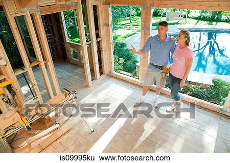 Mature couple standing in construction frame of home extension View Large Photo Image Stock Photograph - Mature couple standing in construction frame of home extension. Fotosearch