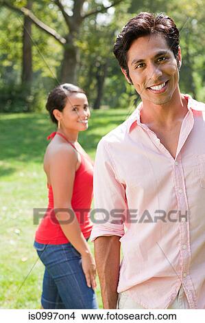 Mid adult couple smiling in park, portrait View Large Photo Image Picture - Mid adult couple smiling in park, portrait. Fotosearch