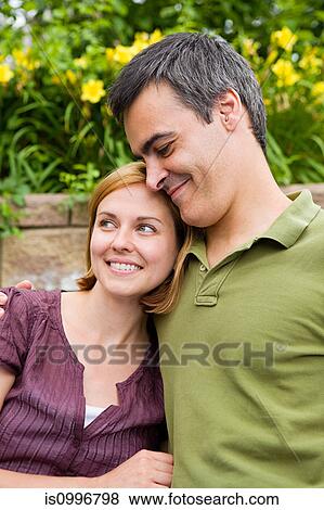 Mid adult couple smiling View Large Photo Image Stock Photo - Mid adult couple smiling. Fotosearch