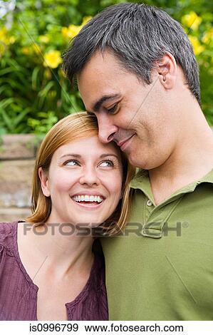 Stock Photo - Mid adult couple smiling. Fotosearch