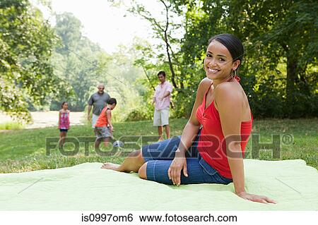 Mid adult woman on blanket in park, portrait View Large Photo Image Stock Photograph - Mid adult woman on blanket in park, portrait. Fotosearch