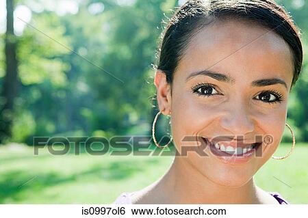 Stock Photograph - Mid adult woman smiling, portrait. Fotosearch