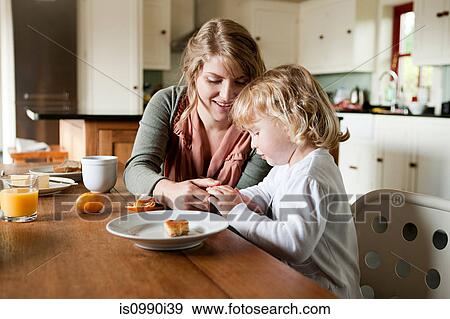 Mother and daughter having breakfast View Large Photo Image Stock Photo - Mother and daughter having breakfast. Fotosearch