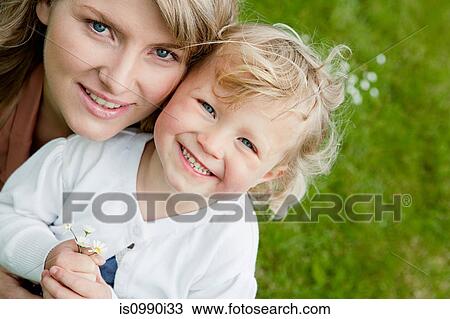 Mother and daughter holding daisies, high angle portrait View Large Photo Image Stock Image - Mother and daughter holding daisies, high angle portrait. Fotosearch