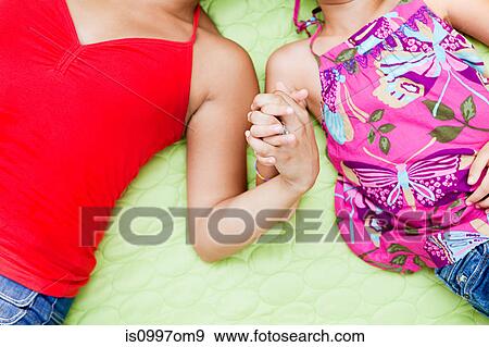 Mother and daughter holding hands, close up View Large Photo Image Stock Photo - Mother and daughter holding hands, close up. Fotosearch