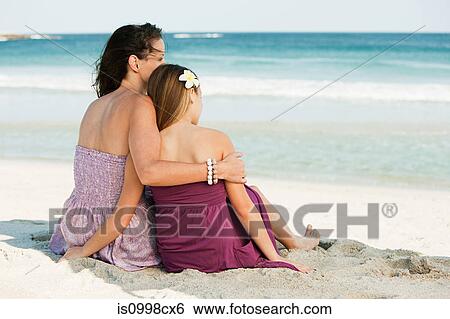 Mother and daughter looking out to sea together View Large Photo Image Stock Photograph - Mother and daughter looking out to sea together. Fotosearch