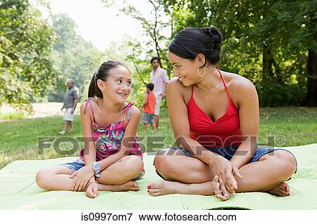 Mother and daughter on picnic blanket in park View Large Photo Image Stock Photo - Mother and daughter on picnic blanket in park. Fotosearch