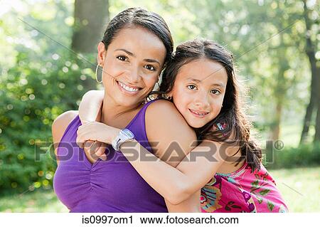 Mother and daughter smiling in park, portrait View Large Photo Image Stock Image - Mother and daughter smiling in park, portrait. Fotosearch