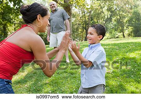Mother playing pat a cake with son in park View Large Photo Image Stock Photography - Mother playing pat a cake with son in park. Fotosearch