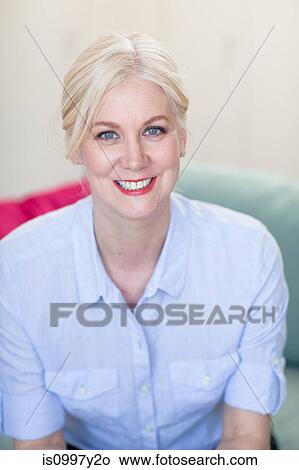 Portrait of a mature woman with blond hair and blue eyes View Large Photo Image Picture - Portrait of a mature woman with blond hair and blue eyes. Fotosearch