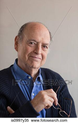 Portrait of a senior man holding glasses in hand View Large Photo Image Stock Photography - Portrait of a senior man holding glasses in hand. Fotosearch