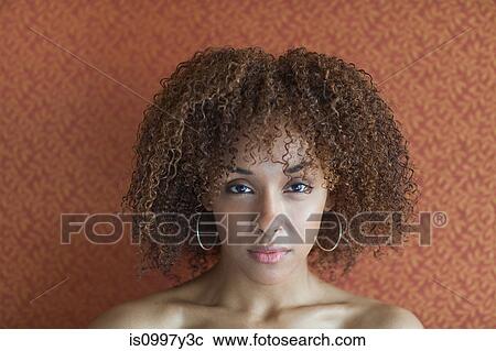Stock Image - Portrait of a young woman looking sultry. Fotosearch