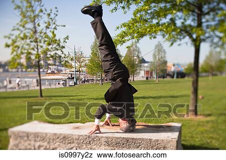 Senior man doing handstand in park View Large Photo Image Stock Photo - Senior man doing handstand in park. Fotosearch