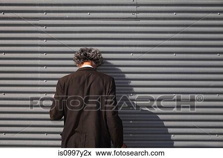 Senior man facing wall with head downturned View Large Photo Image Stock Photo - Senior man facing wall with head downturned. Fotosearch