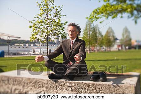 Senior man with legs crossed, meditating in park View Large Photo Image Stock Image - Senior man with legs crossed, meditating in park. Fotosearch