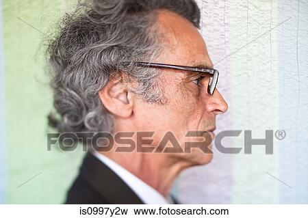Stock Photo - Side profile of senior man wearing glasses. Fotosearch