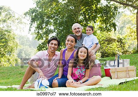 Stock Photo - Three generation family at picnic in park, portrait. Fotosearch