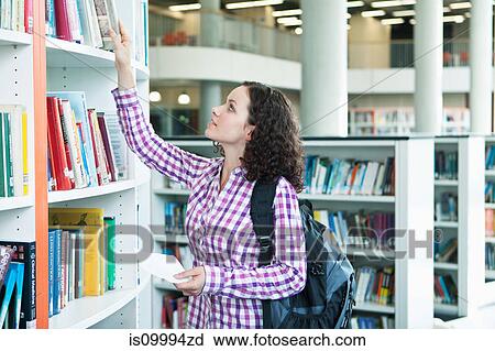 University student choosing textbooks in library View Large Photo Image Stock Image - University student choosing textbooks in library. Fotosearch