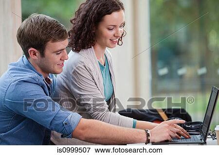 Stock Photo - University student couple working on laptop. Fotosearch