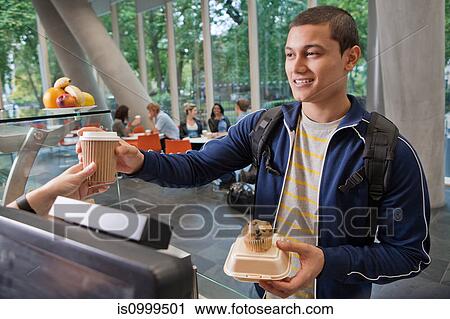 Stock Image - University student paying in college cafe. Fotosearch