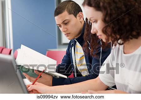 University student studying textbook in class View Large Photo Image Stock Photo - University student studying textbook in class. Fotosearch