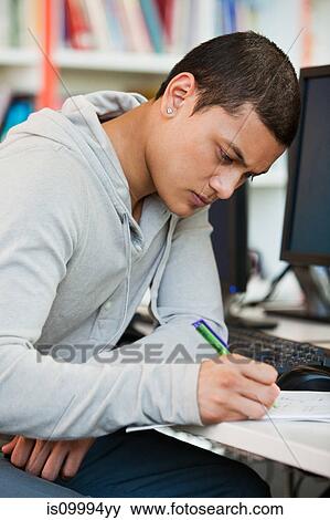 University student working at computer desk View Large Photo Image Stock Photo - University student working at computer desk. Fotosearch