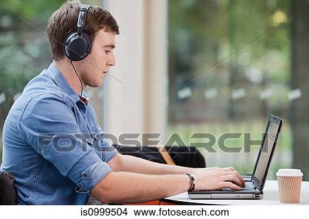 Picture - University student working on laptop. Fotosearch